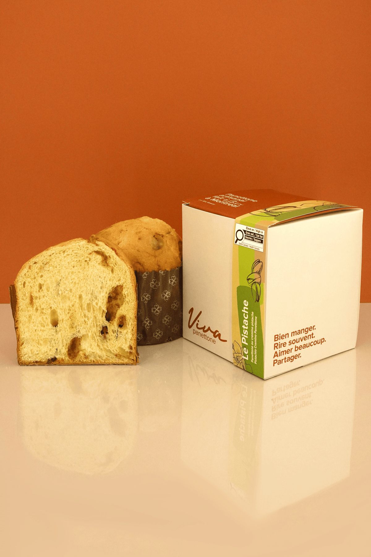 Panettone Le Pistache au cremino pistache tranché devant sa boîte